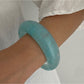 Lovra wide round bangle bracelet shown from above highlighting its circular form