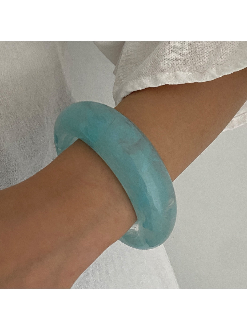 Lovra wide round bangle bracelet shown from above highlighting its circular form