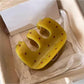 Beau yellow polka dot claw clip holding a section of blonde hair