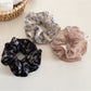 Close-up of Gifty vintage floral print ruffled scrunchie with pink and green flowers