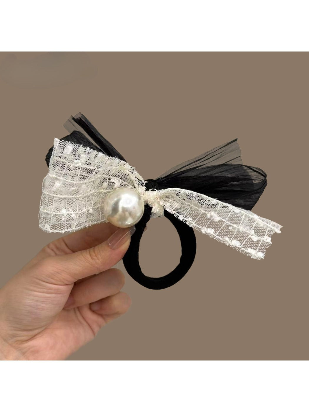 Black elastic hair tie with a classic satin bow adorned with tiny pearl details