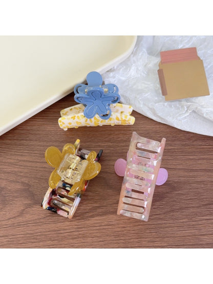 Close-up of Beau flower shaped claw clip showing pink and beige color blocks