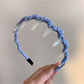 Back view of Gifty polka dot toothed comb headband showing flexible comb teeth