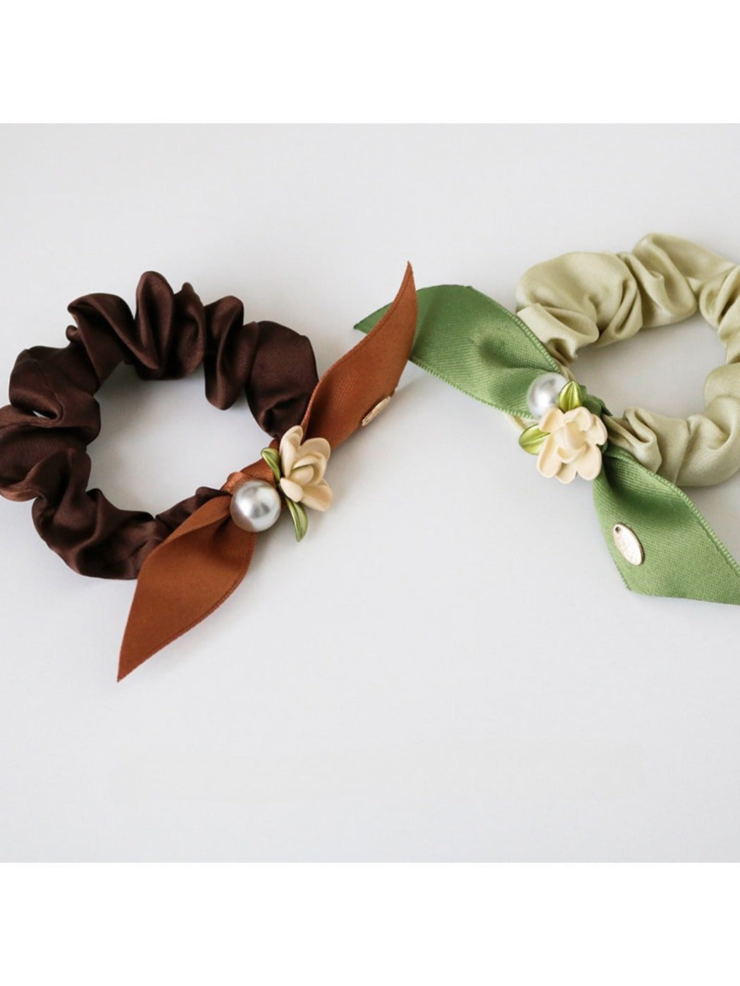 Gifty floral hair tie wrapped around a ponytail on a model with brown hair