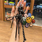 Rainbow sunflower shaped keychain with vibrant multicolor petals and a gold keyring
