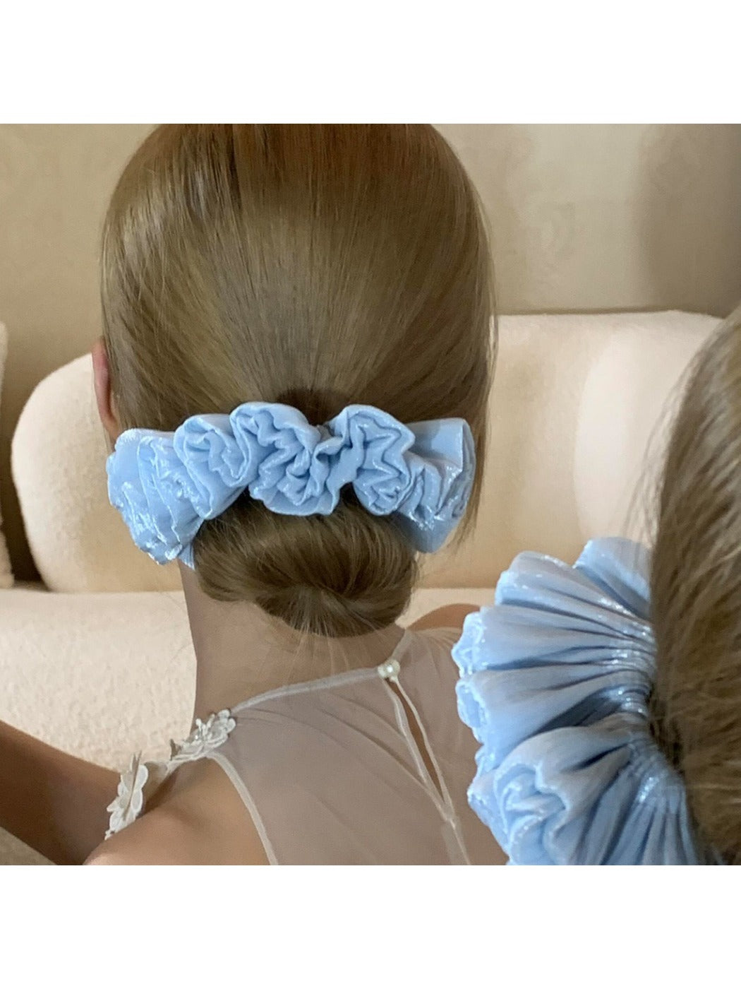 Solid color satin scrunchie showing gathered ruched fabric detail
