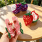 Close-up of Beau peach fruit claw clip showing detailed texture