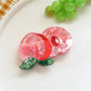 Orange fruit hair clip paired with casual outfit on a wooden table