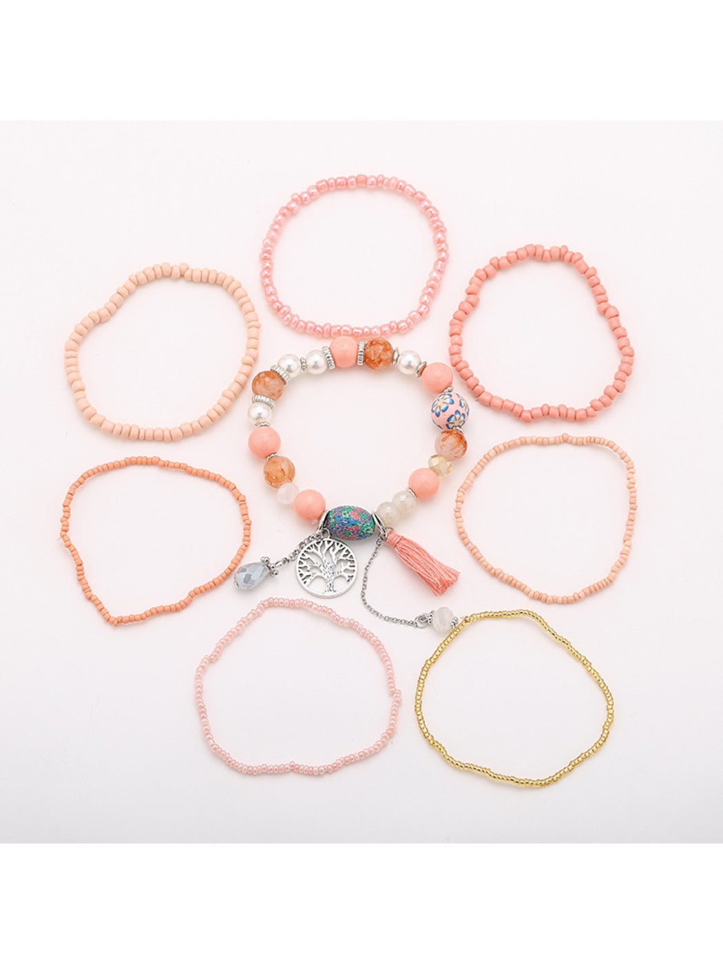 Close-up of tree-shaped tassel pendant on Lovra beaded bracelet showing detailed craftsmanship