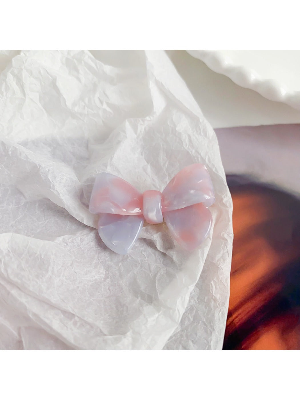 Beau delicate bow hair clip in soft pink with subtle gold thread details