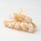 Model wearing Beau flower hair clip with loose waves