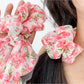 Side view of red floral print bow scrunchie worn in hair