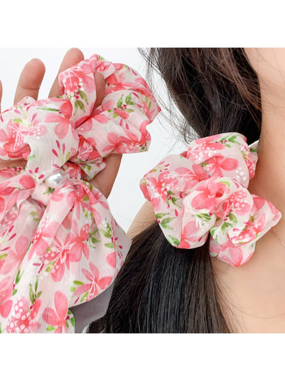 Side view of red floral print bow scrunchie worn in hair