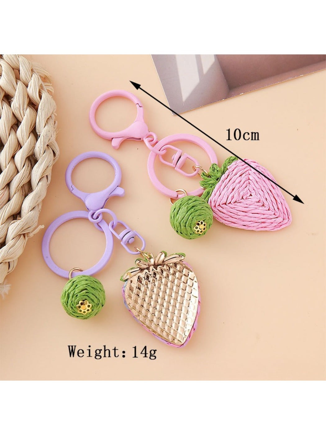 Strawberry charm keychain hanging from a silver keyring on a white background