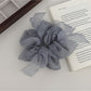 Gifty scrunchie with bow accent styled in a ponytail