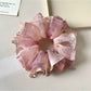Vintage pink scrunchie displayed on a white background showing ruffle details