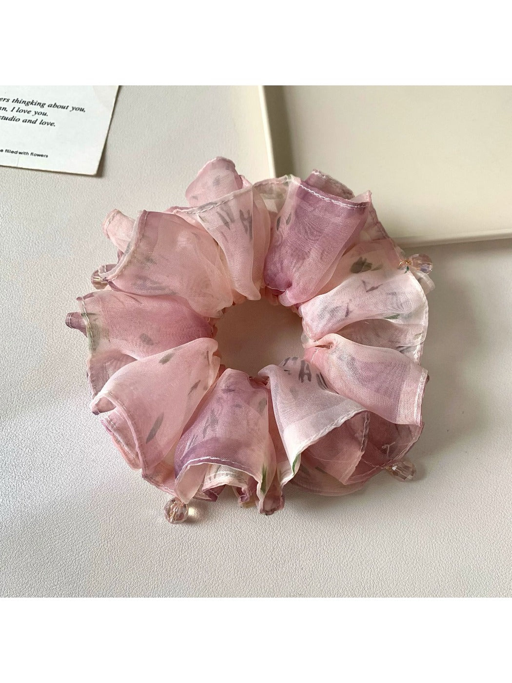 Vintage pink scrunchie displayed on a white background showing ruffle details