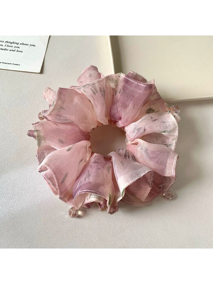 Vintage pink scrunchie displayed on a white background showing ruffle details