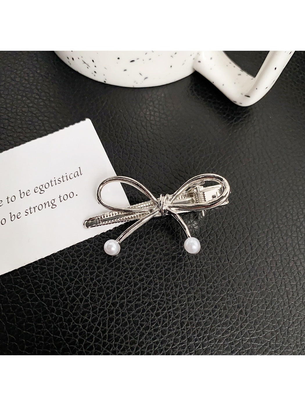 Beau classic bow hair clip in light pink fabric on neutral background