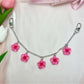 Minimalist flower pendant bag charm styled with casual handbag