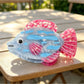 Beau claw clip held in hand to show scale and sea animal shape