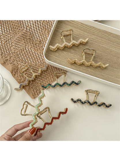 Side view of Beau wavy metal claw clip highlighting metal texture