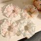 Close-up of Gifty sweet and charming printed scrunchie with floral pattern on fabric