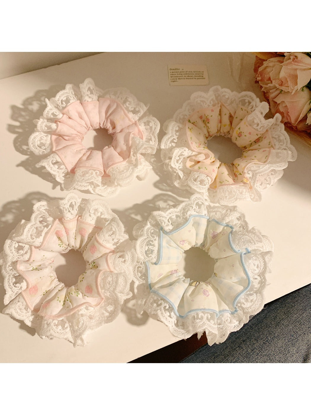 Close-up of Gifty sweet and charming printed scrunchie with floral pattern on fabric