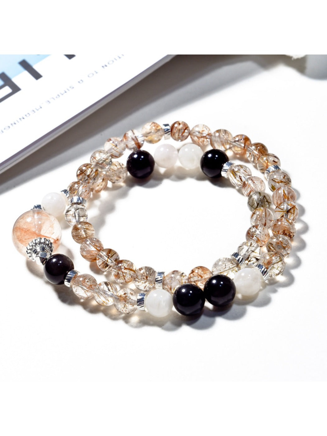 Lovra black gold crystal bracelet displayed flat with clasp visible