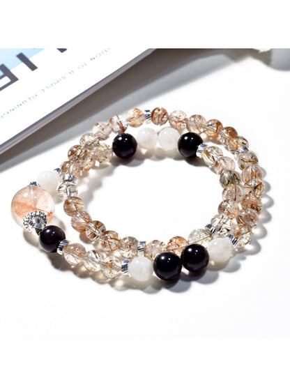 Lovra black gold crystal bracelet displayed flat with clasp visible