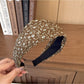 Back view of wide vintage print headband showing elastic band detail