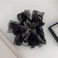 Gifty dark large bow scrunchie displayed flat with bow spread out