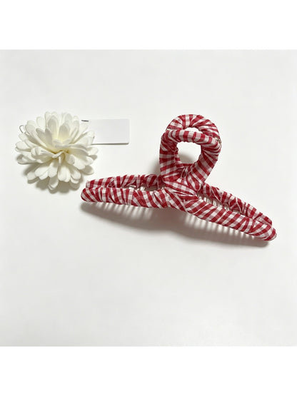 Beau claw clip open showing metal claw mechanism and fabric wrap