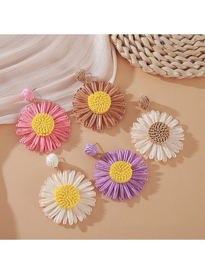 Close-up of vintage raffia woven sunflower earring with yellow petals and brown center