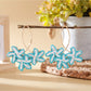 Earedge Sweet Flower Shaped Drop Earrings shown with a soft pink flower background