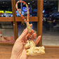 Keypus pony charm keychain held in hand to show size and scale