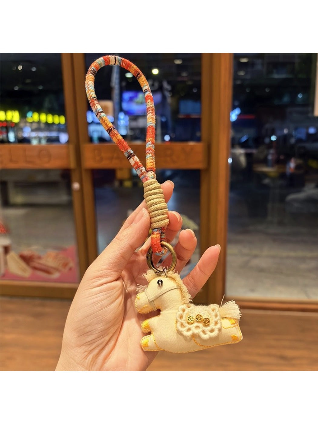 Keypus pony charm keychain held in hand to show size and scale