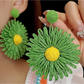 Top view of colorful floral raffia earrings highlighting woven texture