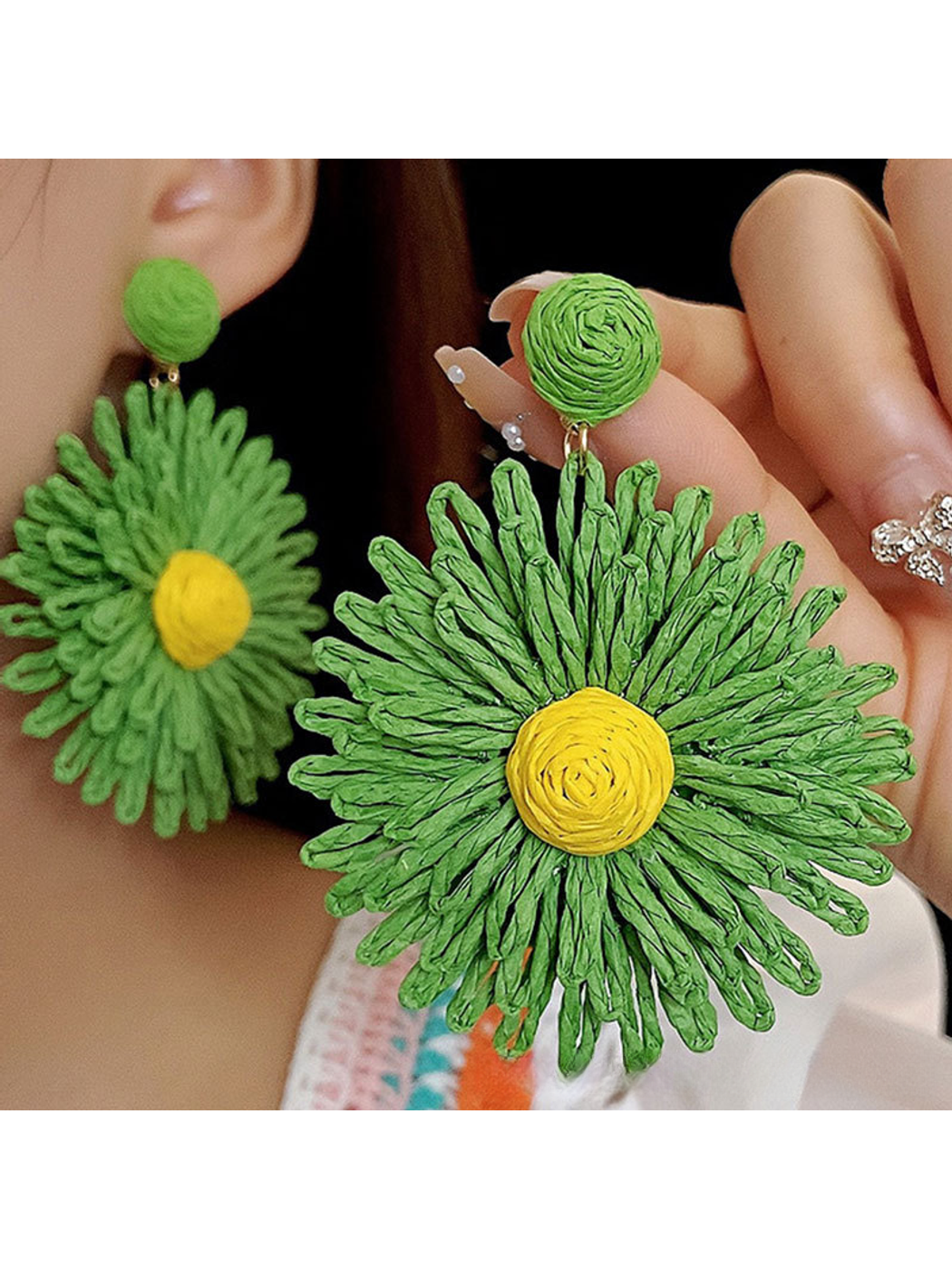 Top view of colorful floral raffia earrings highlighting woven texture