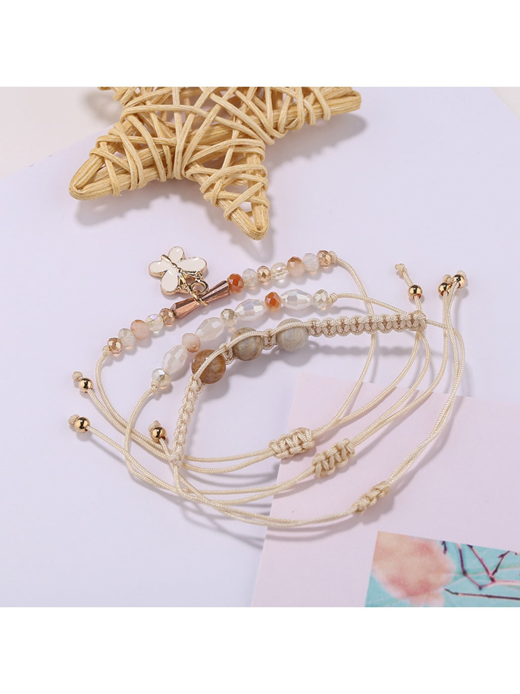 Lovra small bead bracelet with butterfly pendant displayed on white background