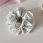 Gifty lace trim scrunchie styled in a ponytail with floral pattern