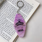 Multiple colorful diamond-shaped pendant keychains arranged in a row