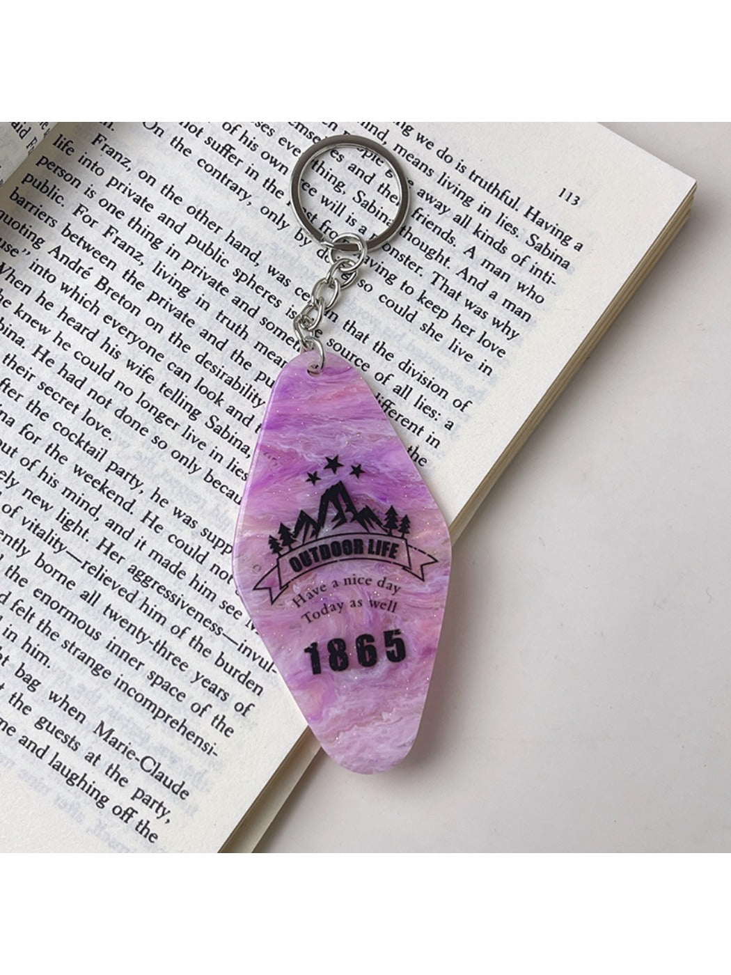 Multiple colorful diamond-shaped pendant keychains arranged in a row