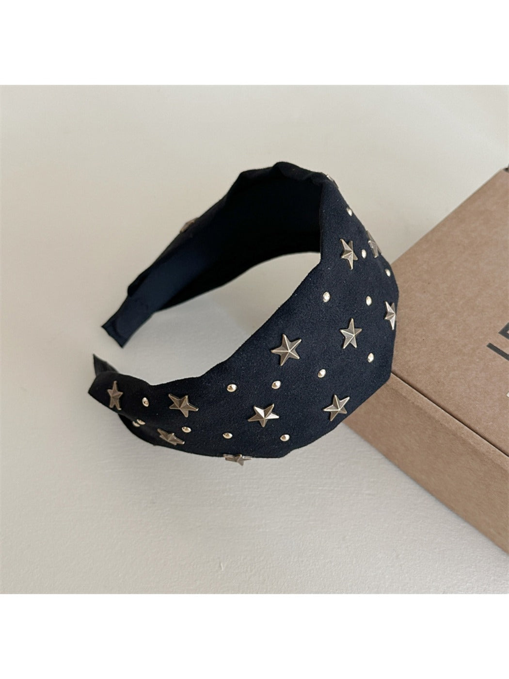 Gifty personalized headband worn on a mannequin head with star decorations