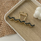 Beau wavy metal claw clip close-up of metal finish and edges
