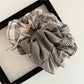 Side view of Gifty vintage plaid patchwork scrunchie highlighting fabric texture