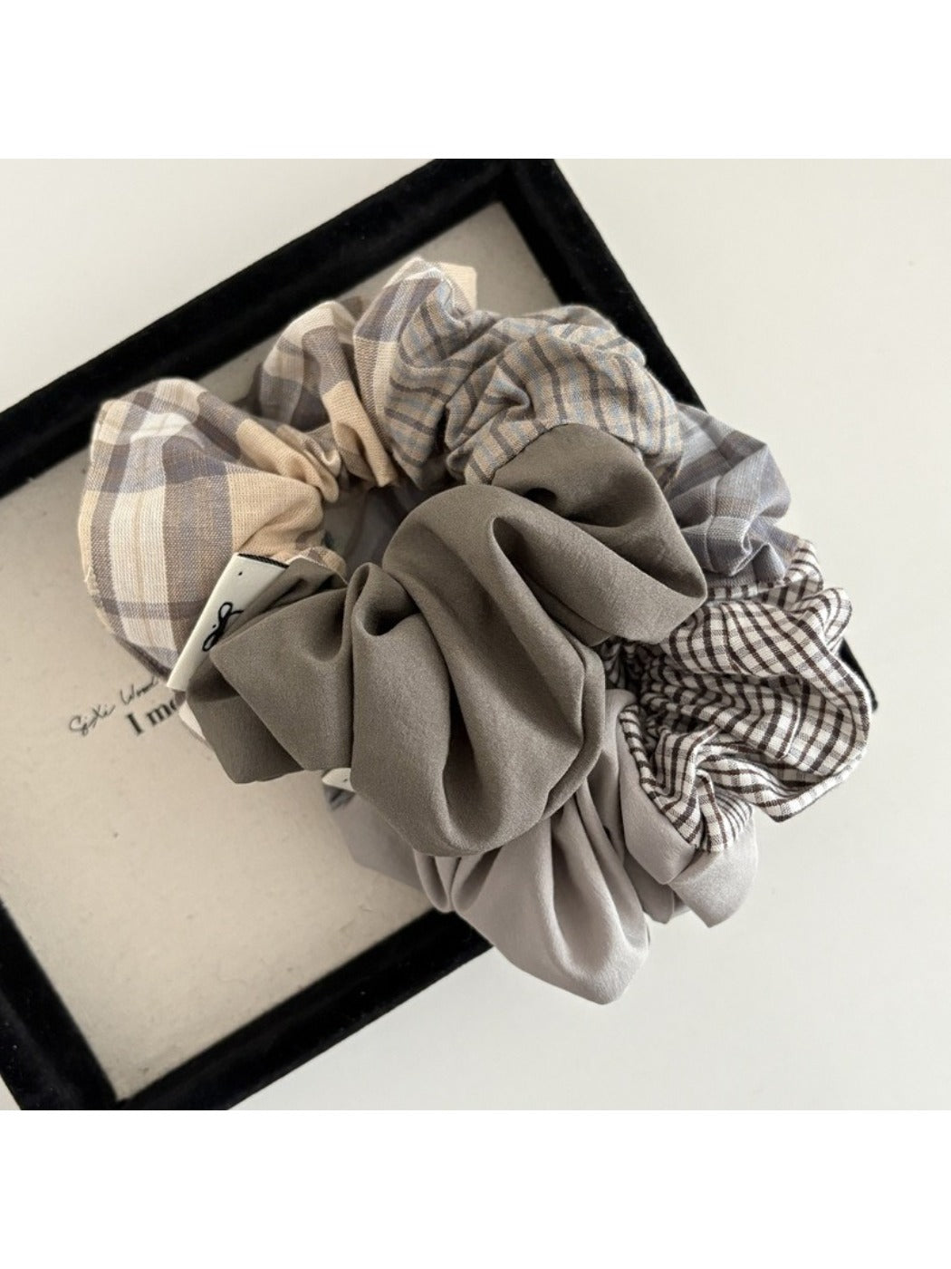 Side view of Gifty vintage plaid patchwork scrunchie highlighting fabric texture