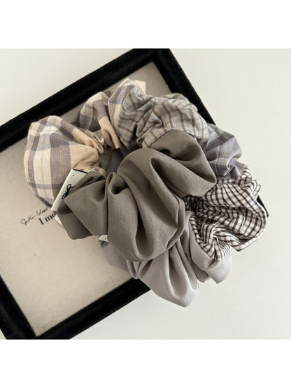 Side view of Gifty vintage plaid patchwork scrunchie highlighting fabric texture