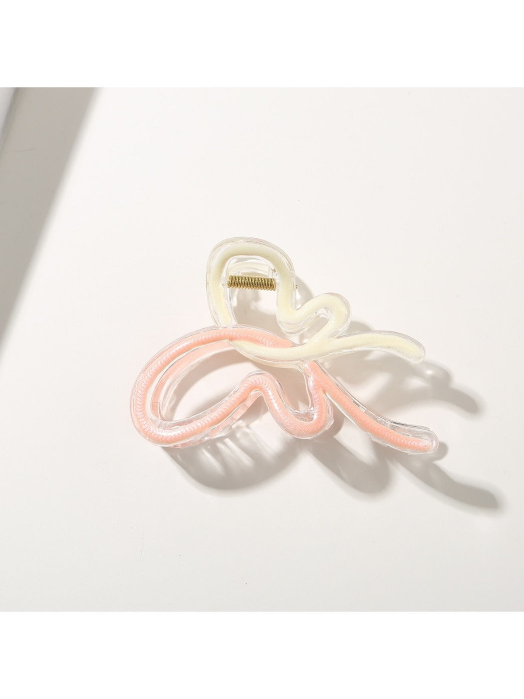 Pastel colored butterfly hair clip clipped onto a ponytail