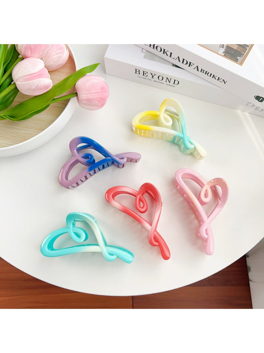 Beau color blocked heart shaped claw clip in pastel pink and beige on white background
